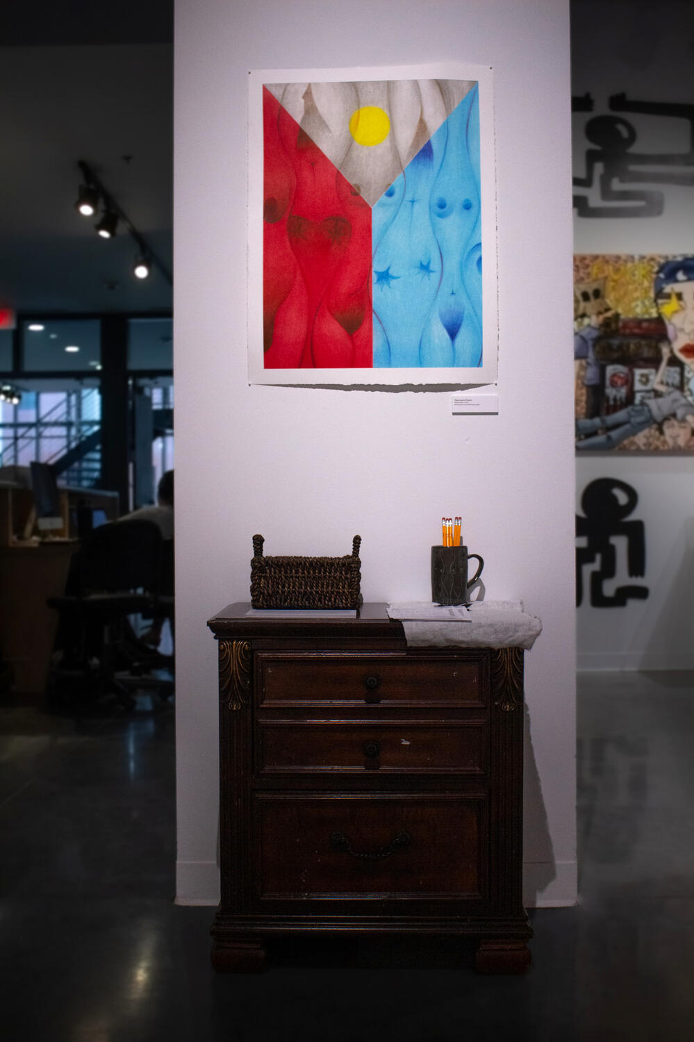 Balikbayan Application, 2024, wooden cabinet, woven basket, handmade mug, embroidered cloth with the Philippines sun motif, 25”x25”x15”